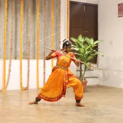 A young dancer performs a piece with a staff, showcasing a unique blend of dance and martial arts at our Platform Performance event.