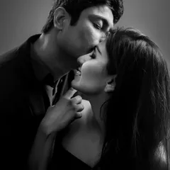 A classic black and white portrait of a tender forehead kiss. The simplicity of monochrome enhances the emotion and intimacy of the gesture.