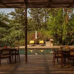 A view of the pool and deck from under the shade of the Pavilion. This perspective shows the seamless flow between our dining and relaxation areas.