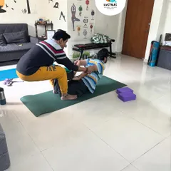 Here, I am assisting a client in a deep backbend. This kind of supported stretching helps improve spinal flexibility and open the chest and shoulders safely.