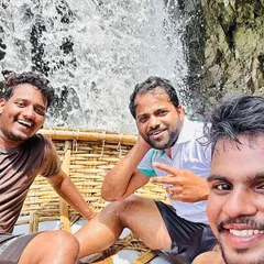 Enjoying a coracle boat ride with friends right next to one of the smaller cascades at Hogenakkal. It's an unforgettable experience.
