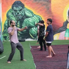 A coach demonstrates the correct striking stance and form to a group of students. Fundamentals are the key to building a strong striking game.