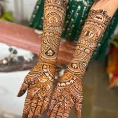 A full view of a custom bridal mehendi featuring a Batman logo, a pet cat, and other personal symbols. Your story is unique, and your henna should be too.