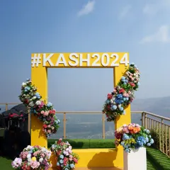 The full setup of the selfie booth, complete with colorful floral arrangements that add a festive touch to the modern design.
