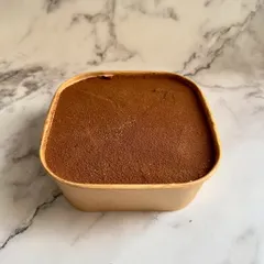 This is my Tiramisu, available in a convenient tub. It's an authentic Italian delight with layers of coffee-soaked ladyfingers and creamy mascarpone with a hint of rum.