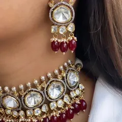A close-up look at the fine making of our polki and ruby choker necklace. Notice the clarity of the uncut stones and the deep red of the ruby beads, designed to give you a look that is not at all less than real gold.