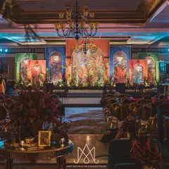 A contemporary sangeet night with a colorful, tropical-themed backdrop. The design captures the spirit of the client and the essence of the space for a vibrant celebration.