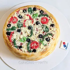 Pizza or cake? This hyper-realistic pizza cake is one of my favorite novelty designs. All the toppings, from the cheese to the veggies, are made from fondant and edible materials.