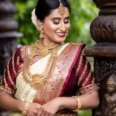 The joy of a bride is unmatched. Here, my client is wearing a beautiful antique Lakshmi haar and choker set that perfectly matches her cream and maroon wedding saree.