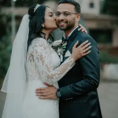 A sweet kiss filled with joy and affection after a Catholic wedding ceremony. These are the unscripted, heartfelt moments that truly define your wedding day.
