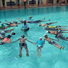 A closer view of our Aqua Yoga participants as they hold a pose together. This water-based exercise promotes stability and core strength in a calm, controlled environment.