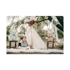 Looking up with a curious smile. This little girl is having a lovely time at her teddy bear picnic, surrounded by nature and her furry friends.