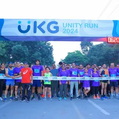 The UKG Unity Run 2024 kicks off. This shot of the starting line, packed with enthusiastic employees in their company-branded purple shirts, shows how I bring a workforce together for a shared fitness goal.