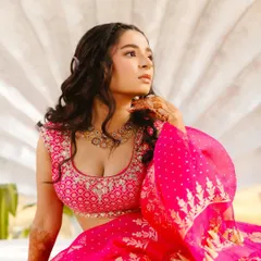 A beautiful portrait of Shree at her Mehendi. The intricate embroidery on her blouse and the soft, wavy hairstyle create a romantic and youthful look.