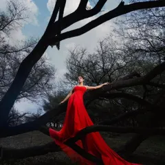 For the bride who is bold and fearless. This vibrant red trail gown looks absolutely stunning against the dramatic, moody backdrop, creating a powerful and artistic pre-wedding photograph.
