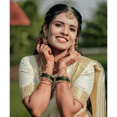 The quintessential happy bride. This portrait captures the pure joy and radiance of a bride in her traditional Kerala kasavu saree, her smile lighting up the frame.