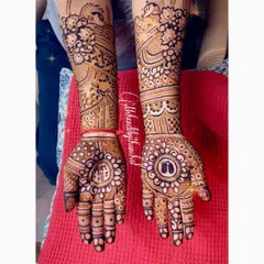 A full baby shower mehendi for the mom-to-be. The design includes baby feet inside a central mandala, surrounded by beautiful floral and peacock patterns.