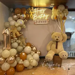 For this first birthday, we created a full teddy bear theme with a custom neon sign, a large teddy bear prop, and a balloon arch in earthy tones of cream, brown, and rose gold.