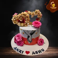 This unique anniversary cake features a hand-painted design of a couple holding hands, framed by fresh pink roses. The heart-shaped floral topper adds an extra layer of romance, making it a truly artistic and personal piece.
