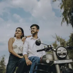 Looking out at the horizon, together. A cool, relaxed portrait of the couple with their bike, ready for whatever adventure comes next.