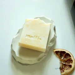 Wake up your senses with this energizing blend of orange and bergamot. This bar rests on one of my handmade concrete trays, next to a dried orange slice.