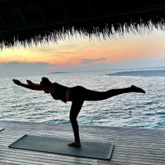 Finding my balance in Warrior III pose, or Virabhadrasana III. This pose challenges your stability and focus, and practicing it with the ocean in the background is a reminder to stay steady even when things are in motion.