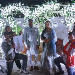 A picture perfect moment after a surprise engagement flashmob. Our dancers pose with the happy couple on stage, holding up custom illustrated portraits as part of the celebration.