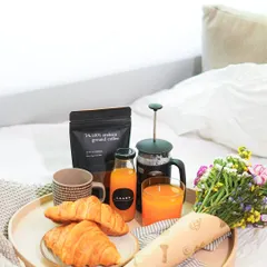 A simple yet elegant Mother's Day gesture. Our breakfast-in-bed tray includes freshly baked croissants, a bottle of fresh juice, our signature ground coffee with a French press, and a bouquet of flowers.