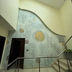 This was a surprise project where the client approved the design on the spot for this massive double-height wall. I created a textured, abstract mural with stenciled patterns and gold foil circles.