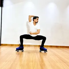 A powerful pose on roller skates, demonstrating the core strength and balance required for artistic skating.
