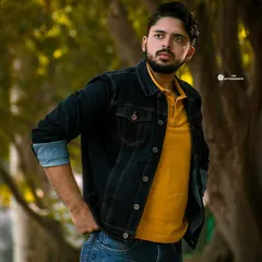 A classic men's portrait taken outdoors. The focus here is on a natural, confident look, using the soft light and background to make the subject stand out.