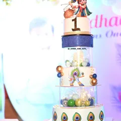 A taller, multi-tier version of our Krishna-themed cake, perfect for a larger celebration. This design incorporates separator tiers filled with colorful baubles.