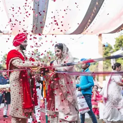 The ribbon-cutting ceremony at a Sikh wedding, a fun and festive tradition captured with a shower of heart-shaped confetti.