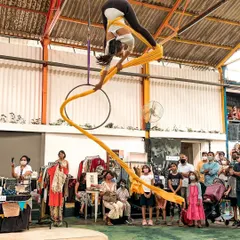 Experience the thrill of defying gravity. This shot captures the grace and strength of an aerial silk performance during one of our community events. Our workshops make this beautiful art form accessible to everyone, regardless of experience.
