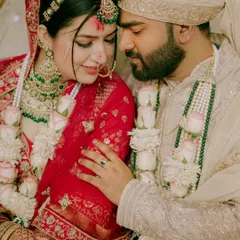 A close up, emotional moment between the bride and groom after the Varmala ceremony. This frame is filled with love, tradition, and the beautiful colors of their wedding attire.