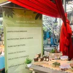My stall at a local farmers market, showcasing my range of lentil breads, nutritional bars, and pure nut butters. I love these events for the chance to meet customers in person.