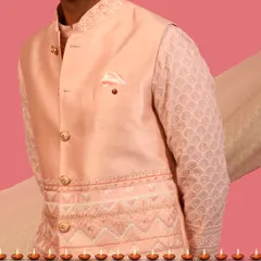 A detailed shot of a peach Nehru jacket layered over a chikankari kurta. This combination showcases my approach to mixing different embroidery styles for a rich, textured look that feels both traditional and new.