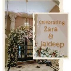 A grand and elegant entrance for a wedding reception. The doorway was framed with a massive arch of white flowers, creating a stunning first impression for guests.