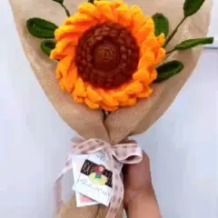 Here is a large, single statement sunflower bouquet I created. The bright yellow petals and detailed brown center are complemented by crocheted green leaves and a rustic burlap wrap, tied with a simple ribbon.