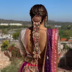 For this Mehndi look, I designed an intricate statement braid and adorned it with a stunning, oversized traditional hair accessory. This style is not only beautiful from the back but also practical for a long event.