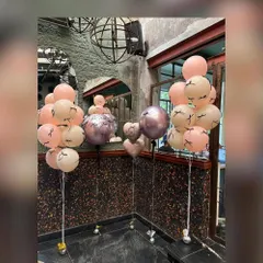 Custom balloon bunches for a stylish bridal shower. These arrangements feature a mix of pastel, metallic, and custom-printed balloons with eyelash details, adding a fun and fashionable touch to the party decor.