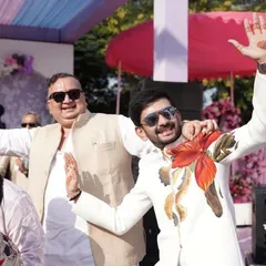 Capturing the joy of the celebration, this client is wearing another of my custom hand-painted bandhgalas. The vibrant red and orange floral artwork on the white jacket brings energy and artistic flair to his festive attire.