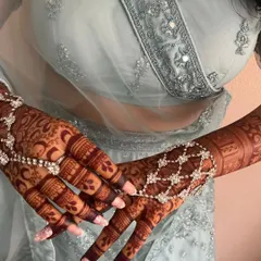 The rich, dark stain of my organic henna, beautifully complemented by elegant hand jewelry. This is the result you can expect with proper aftercare.