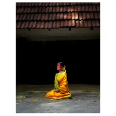 Another frame from the conceptual Haldi series. Here, the model looks towards a sliver of light, creating a sense of hope and contemplation under the traditional tiled roof.