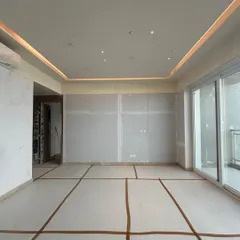 Another view of the Conscient Parq show apartment in Gurugram during construction. The cove lighting is installed, giving a hint of the warm, ambient glow that will soon fill the space.