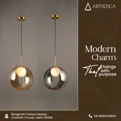 These modern globe pendants showcase a unique half-and-half design, combining clear glass with a metallic finish. Available in both amber and smoke tints, they offer a contemporary charm that hangs with purpose.