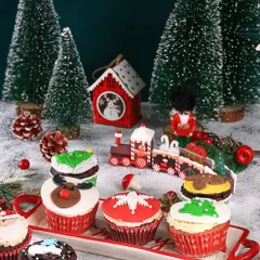 Christmas cupcakes arranged on a festive tray, styled to look like a sweet holiday train ready for delivery.
