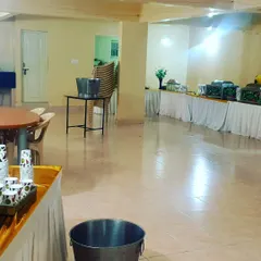 A wide view of a basic event hall during setup. This shows that I can handle catering in various environments, from large convention centers to smaller community halls.