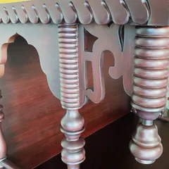 A detail shot of the turned and fluted pillars of a wooden puja unit. No machine can replace the heart and soul my artisans put into their work, and it shows in these intricate details.
