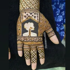 A creative take on a gender reveal henna design. This silhouette of a mother holding her baby is framed by 'Boy' and 'Girl' text, making it a centerpiece for the Godh Bharai ceremony.